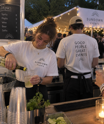 Staff wearing personalized ShirtUp! T-shirts at a food stand